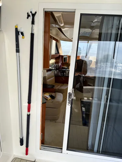 Continuous Wave Yacht Photos Pics Interior view of a 2007 Meridian 391 yacht through a glass door, with cleaning tools attached.