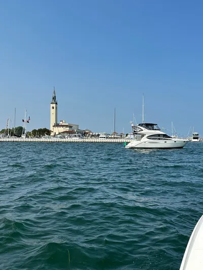 Continuous Wave Yacht Photos Pics 2007 Meridian 391 yacht cruising near a marina with a clock tower.