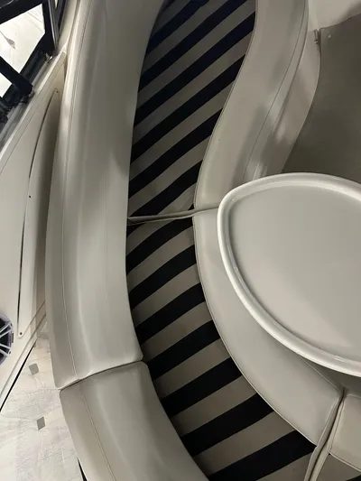Continuous Wave Yacht Photos Pics Interior seating of 2007 Meridian 391 yacht with striped cushions and table.
