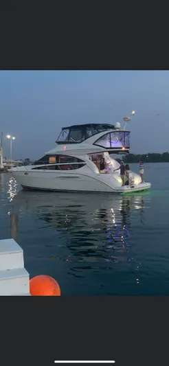 Continuous Wave Yacht Photos Pics 2007 Meridian 391 yacht illuminated at dusk on calm waters.