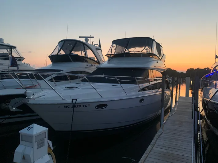 Continuous Wave Yacht Photos Pics 2007 Meridian 391 yacht docked at sunset, with neighboring boats and calm water.