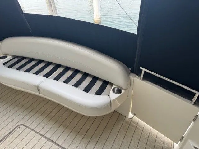 Continuous Wave Yacht Photos Pics Luxury seating area on a 2007 Meridian 391 yacht with striped cushion and cup holders.