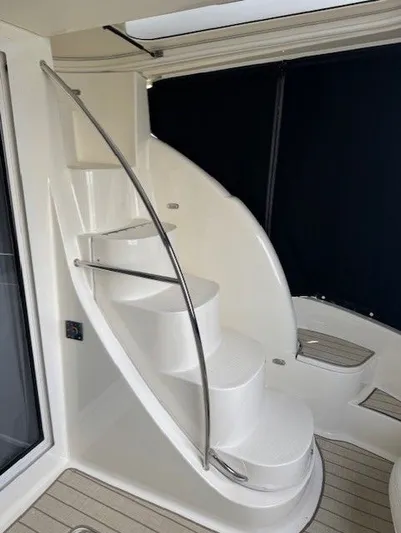 Continuous Wave Yacht Photos Pics Curved staircase on 2007 Meridian 391 yacht with sleek metal railing.