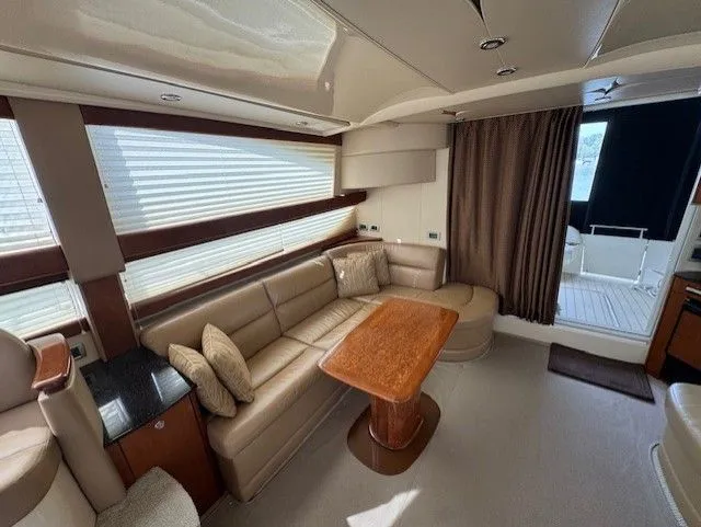 Continuous Wave Yacht Photos Pics Luxurious 2007 Meridian 391 yacht interior with leather seating and wooden table.