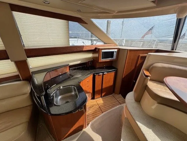 Continuous Wave Yacht Photos Pics Luxurious 2007 Meridian 391 yacht interior with kitchenette and seating area.