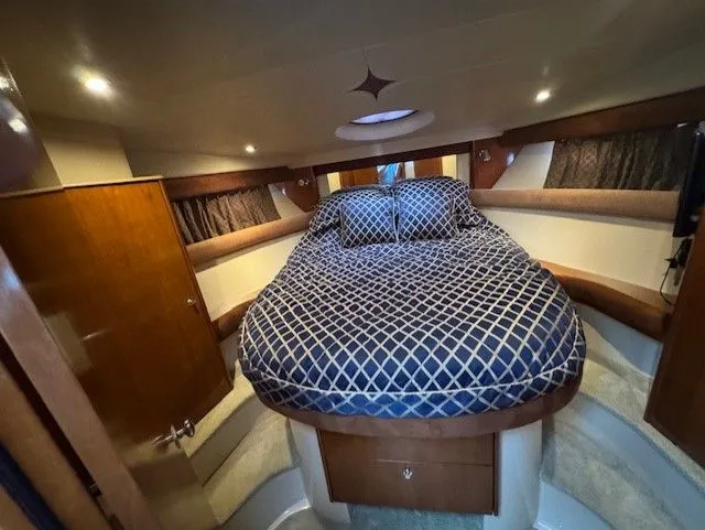 Continuous Wave Yacht Photos Pics Luxurious 2007 Meridian 391 yacht bedroom with elegant bedding and ambient lighting.