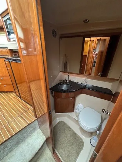 Continuous Wave Yacht Photos Pics 2007 Meridian 391 yacht bathroom with wood accents, sink, and toilet.