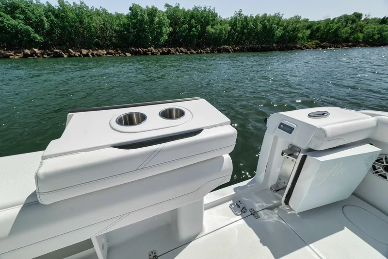 36 Offshore Yacht Photos Pics 2025 Yellowfin 36 Offshore boat interior with cup holders, near lush shoreline.