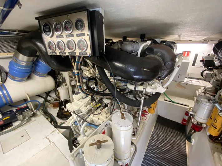 Rock Mama Yacht Photos Pics Engine room of 2001 Hatteras 55 Convertible yacht, showcasing gauges and machinery.