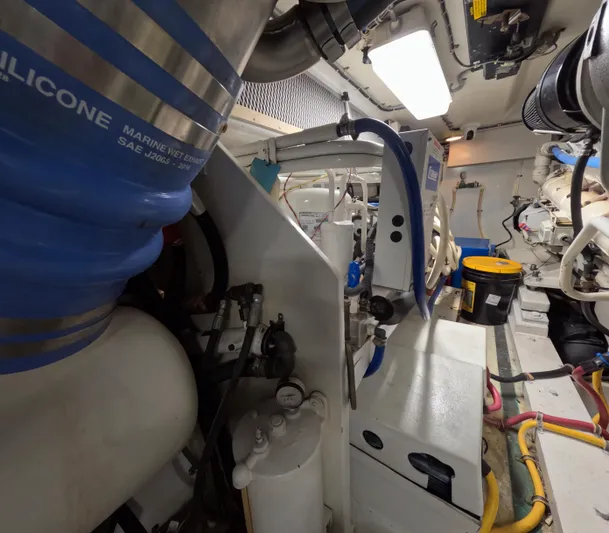 Rock Mama Yacht Photos Pics Engine room of a 2001 Hatteras 55 Convertible yacht, showcasing mechanical components and equipment.