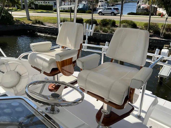 Rock Mama Yacht Photos Pics Captain's chairs on 2001 Hatteras 55 Convertible yacht, overlooking marina.