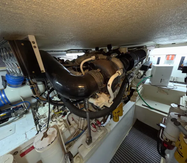 Rock Mama Yacht Photos Pics Engine room of a 2001 Hatteras 55 Convertible yacht, showcasing complex machinery and components.