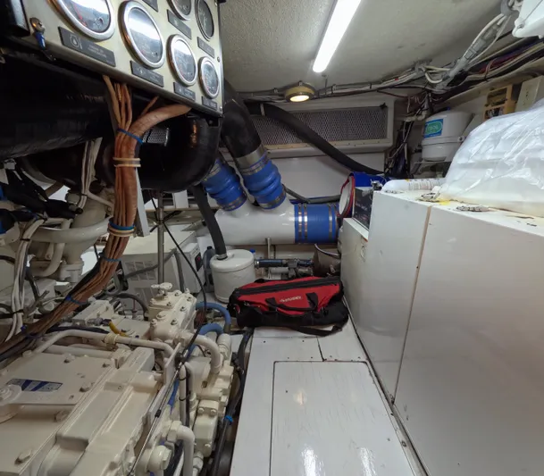 Rock Mama Yacht Photos Pics Engine room of a 2001 Hatteras 55 Convertible yacht, featuring gauges and mechanical components.