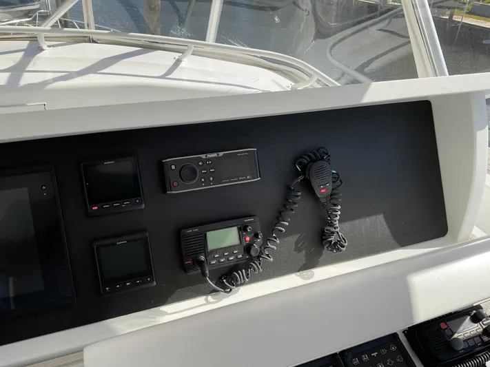 Rock Mama Yacht Photos Pics Control panel of 2001 Hatteras 55 Convertible yacht with communication devices.