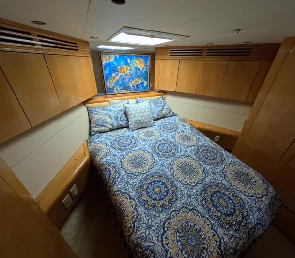 Rock Mama Yacht Photos Pics Luxurious cabin interior of 2001 Hatteras 55 Convertible yacht with patterned bedding.