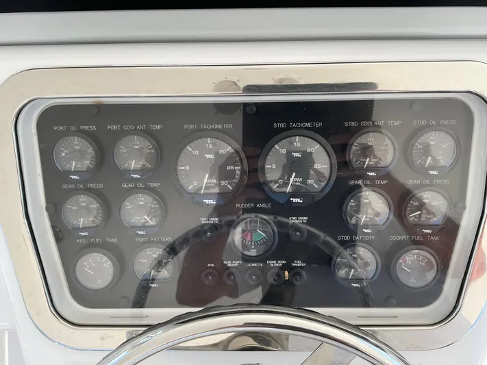 Rock Mama Yacht Photos Pics Instrument panel of a 2001 Hatteras 55 Convertible yacht, featuring various gauges and controls.