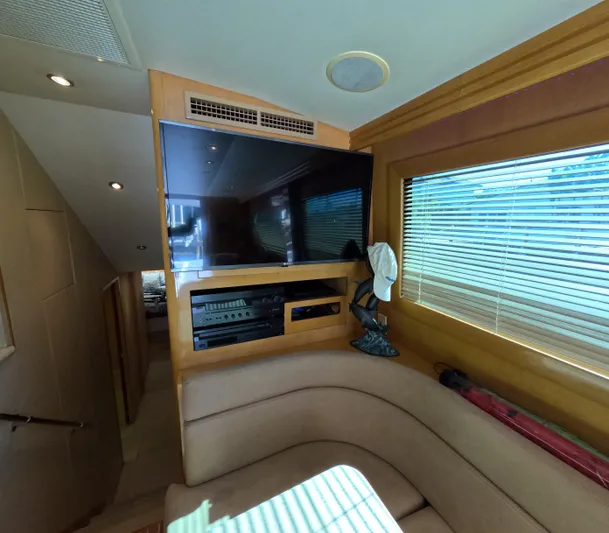 Rock Mama Yacht Photos Pics Interior of 2001 Hatteras 55 Convertible yacht with TV and seating area.