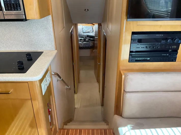 Rock Mama Yacht Photos Pics Interior view of 2001 Hatteras 55 Convertible yacht, featuring kitchen and hallway to cabin.