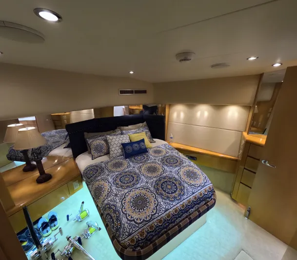 Rock Mama Yacht Photos Pics Luxurious bedroom interior of 2001 Hatteras 55 Convertible yacht with elegant bedding.