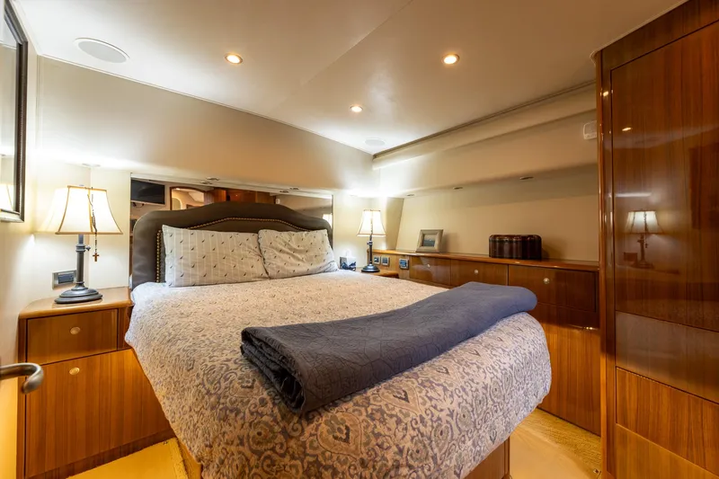 Miss Ella Maye Yacht Photos Pics Luxurious bedroom interior of 2008 Viking 54 Sport Fisher yacht with cozy bed and elegant lighting.