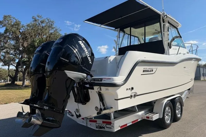  Yacht Photos Pics 2017 Boston Whaler 285 Conquest boat with dual Mercury engines on a trailer.