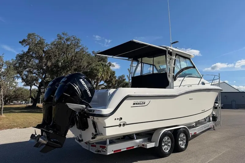  Yacht Photos Pics 2017 Boston Whaler 285 Conquest boat on trailer, featuring twin Mercury engines.