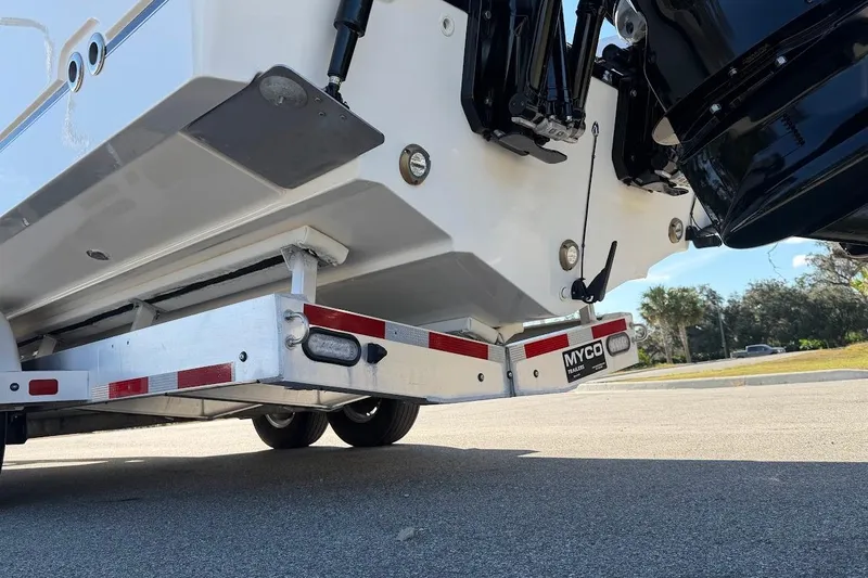  Yacht Photos Pics 2017 Boston Whaler 285 Conquest on Myco trailer, rear view with outboard motor.