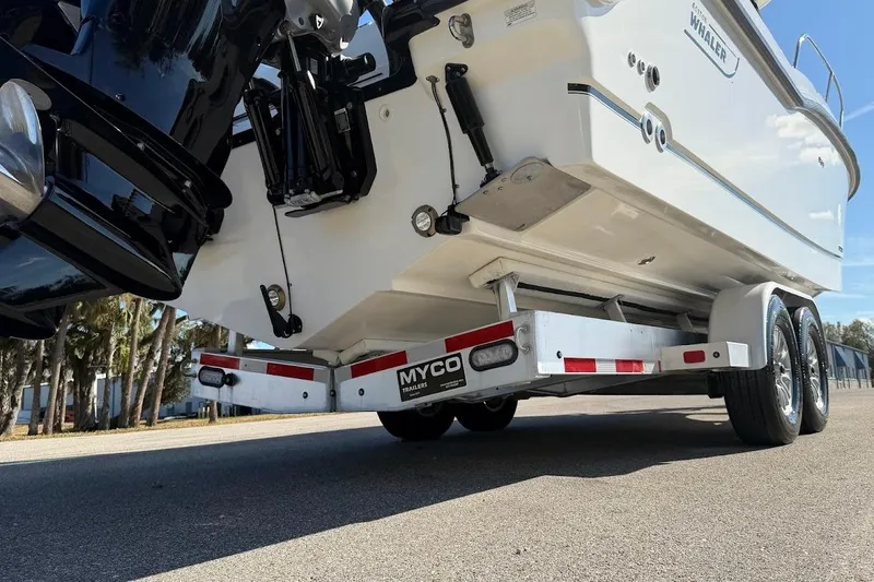  Yacht Photos Pics 2017 Boston Whaler 285 Conquest on Myco trailer, rear view, parked on road.