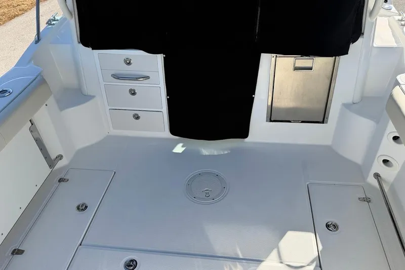  Yacht Photos Pics 2017 Boston Whaler 285 Conquest boat interior with storage compartments and seating.