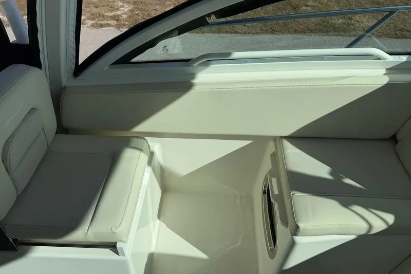  Yacht Photos Pics Interior seating of 2017 Boston Whaler 285 Conquest boat, featuring cream-colored upholstery.