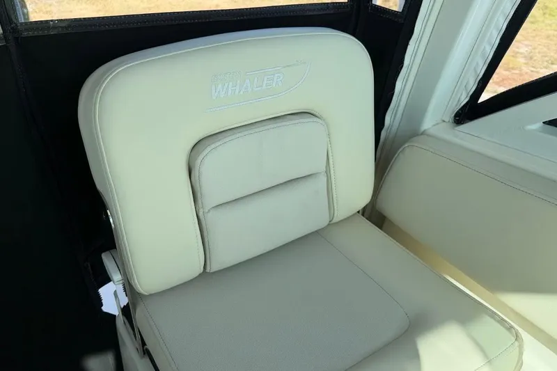 Yacht Photos Pics 2017 Boston Whaler 285 Conquest seat with logo, featuring beige upholstery.
