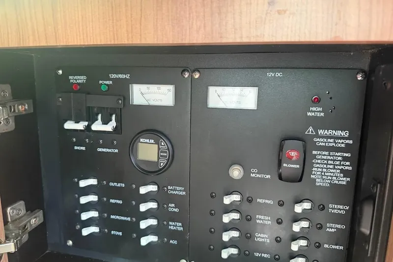  Yacht Photos Pics Control panel of a 2017 Boston Whaler 285 Conquest boat, featuring various switches and gauges.