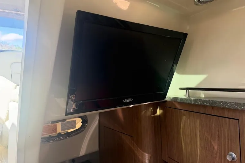  Yacht Photos Pics Interior of 2017 Boston Whaler 285 Conquest with mounted TV and wooden cabinetry.
