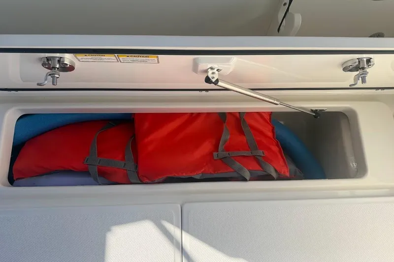  Yacht Photos Pics Storage compartment with life jackets on a 2017 Boston Whaler 285 Conquest boat.