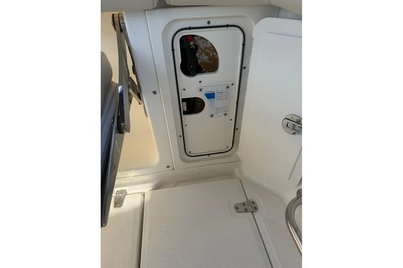  Yacht Photos Pics 2017 Boston Whaler 285 Conquest interior compartment with access panel and latch.