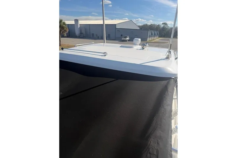  Yacht Photos Pics 2017 Boston Whaler 285 Conquest boat deck with black cover, outdoor setting.