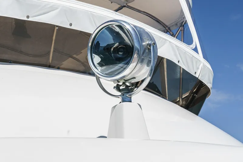 Maverick Yacht Photos Pics 1979 Hatteras 58 Motor Yacht spotlight against clear blue sky.