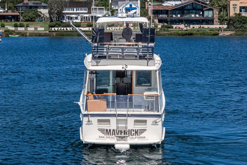 Maverick Yacht Photos Pics 1979 Hatteras 58 Motor Yacht on water, San Diego, California backdrop.