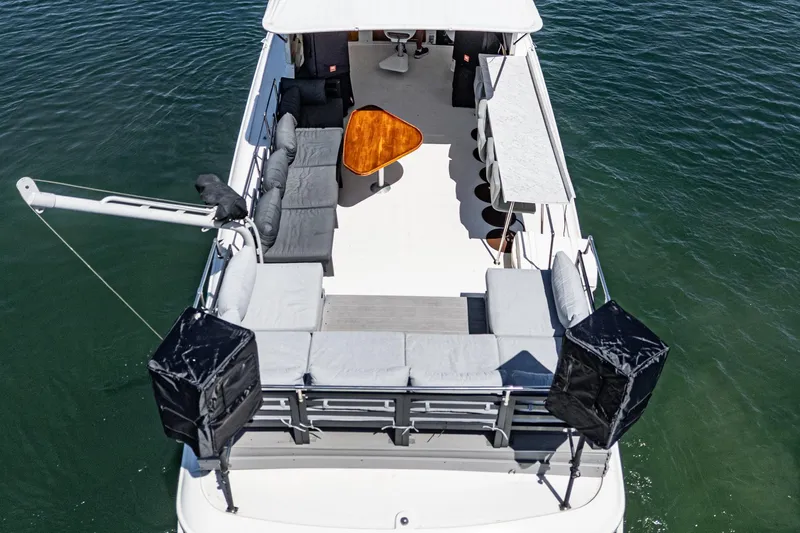 Maverick Yacht Photos Pics 1979 Hatteras 58 Motor Yacht with spacious deck and seating, cruising on water.