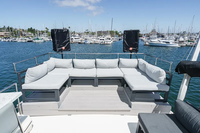 Maverick Yacht Photos Pics 1979 Hatteras 58 Motor Yacht deck with cushioned seating, overlooking marina.