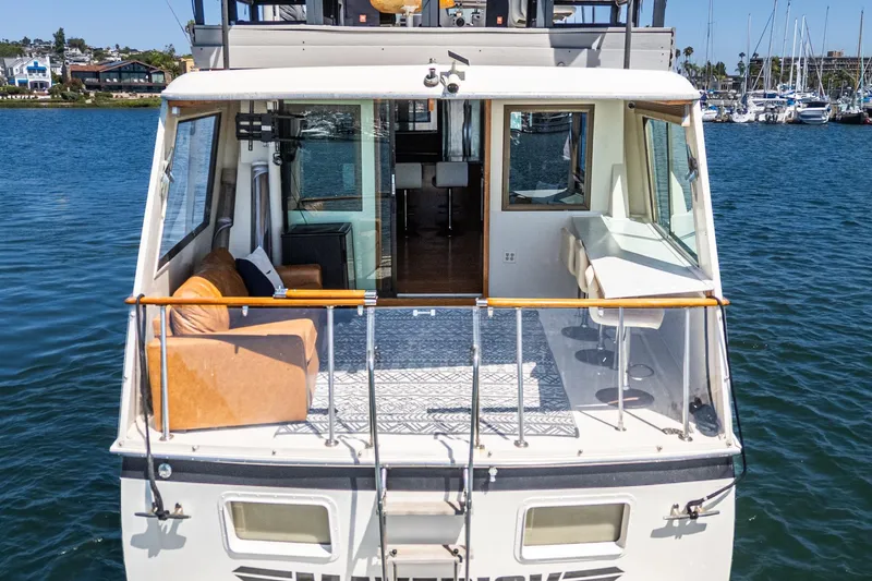 Maverick Yacht Photos Pics 1979 Hatteras 58 Motor Yacht with spacious deck and comfortable seating on the water.