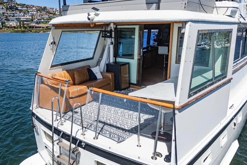 Maverick Yacht Photos Pics 1979 Hatteras 58 Motor Yacht with elegant deck and scenic waterfront view.