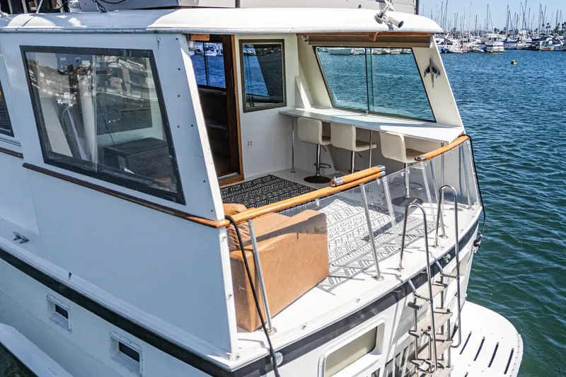 Maverick Yacht Photos Pics 1979 Hatteras 58 Motor Yacht with spacious deck and marina view.