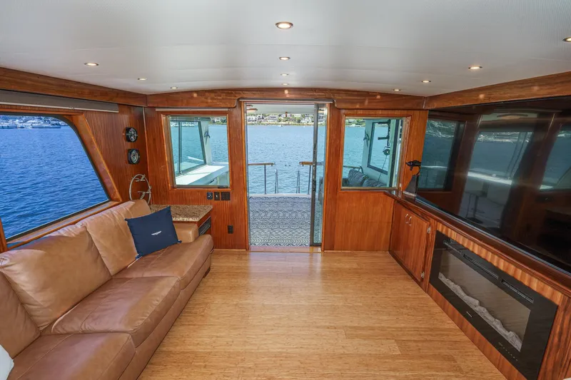 Maverick Yacht Photos Pics Luxurious interior of 1979 Hatteras 58 Motor Yacht with leather seating and waterfront view.