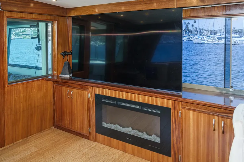 Maverick Yacht Photos Pics Interior of 1979 Hatteras 58 Motor Yacht with TV and fireplace, overlooking marina.