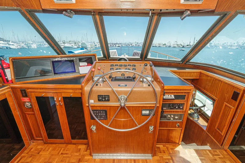 Maverick Yacht Photos Pics 1979 Hatteras 58 Motor Yacht helm with wooden interior and ocean view.