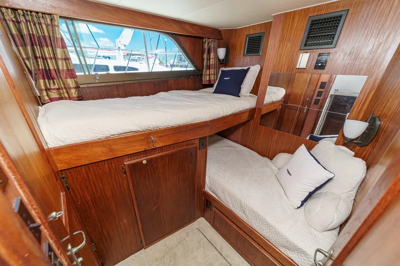 Maverick Yacht Photos Pics 1979 Hatteras 58 Motor Yacht cabin with wooden interior and bunk beds.