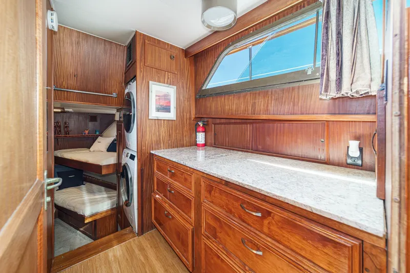 Maverick Yacht Photos Pics Interior of 1979 Hatteras 58 Motor Yacht with wood cabinetry and laundry area.