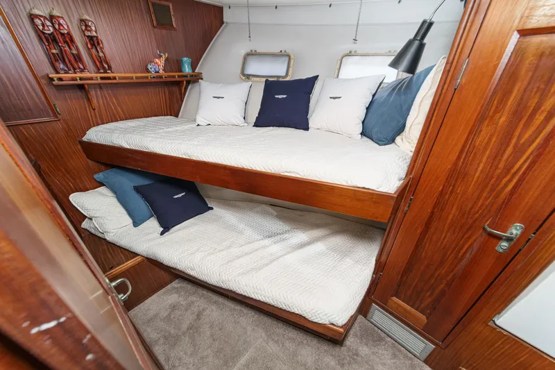Maverick Yacht Photos Pics 1979 Hatteras 58 Motor Yacht cabin with wooden bunk beds and nautical decor.