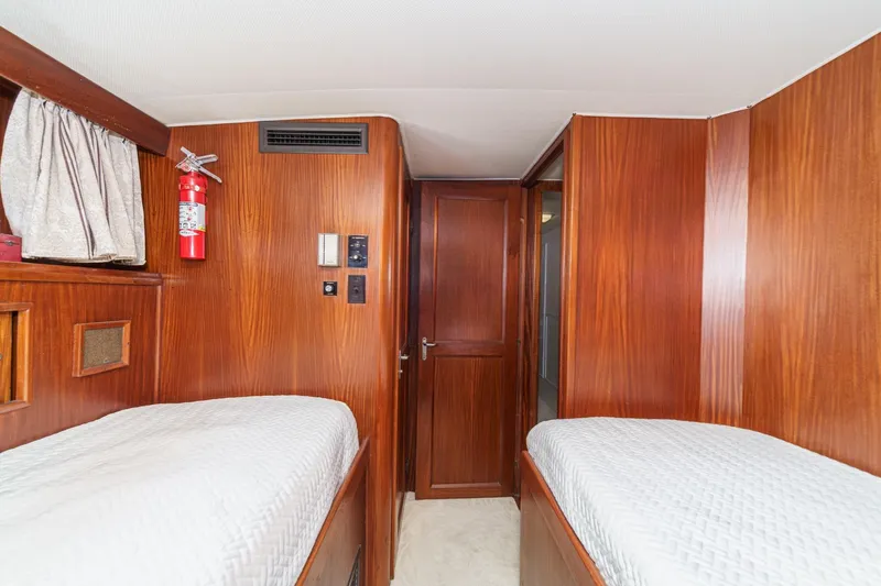 Maverick Yacht Photos Pics Interior cabin of 1979 Hatteras 58 Motor Yacht with twin beds and wood paneling.